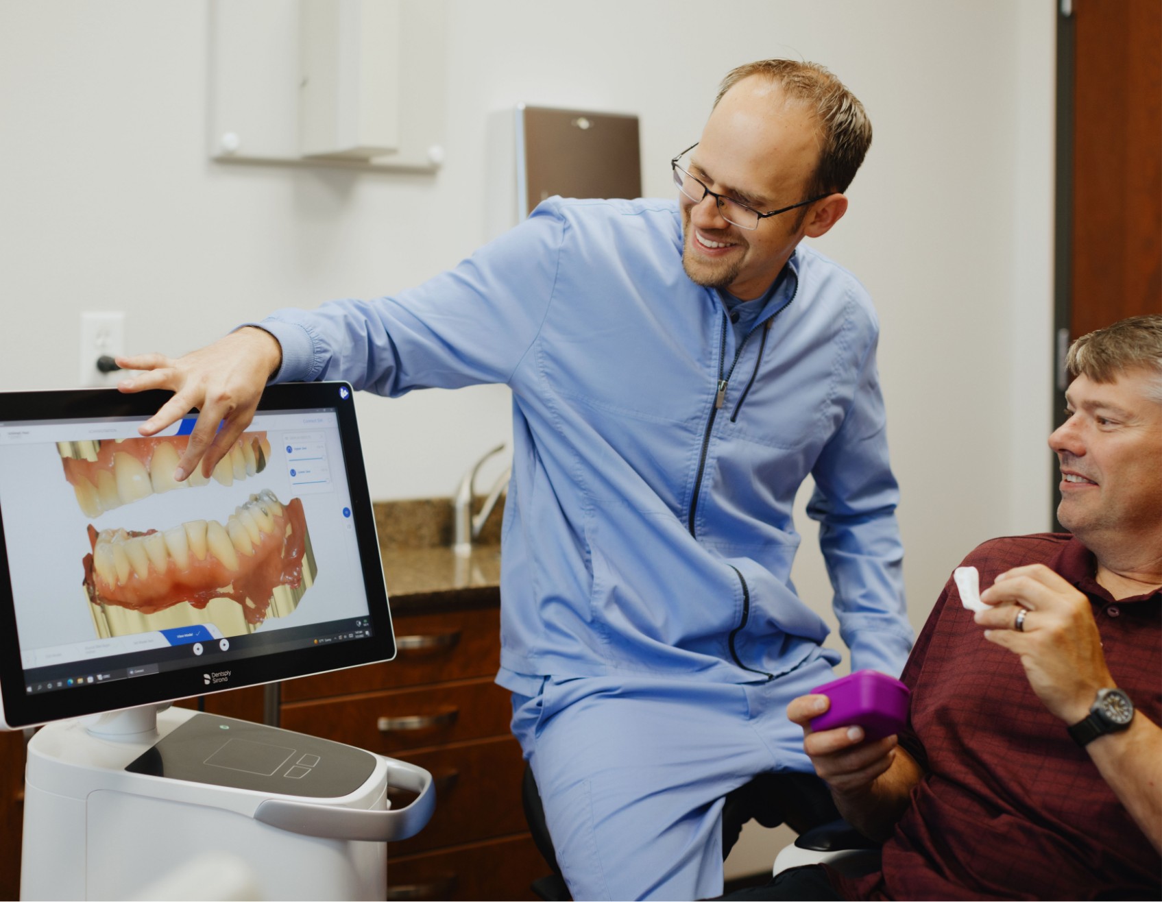 Dr. Adam Milmont smiling with a male patient