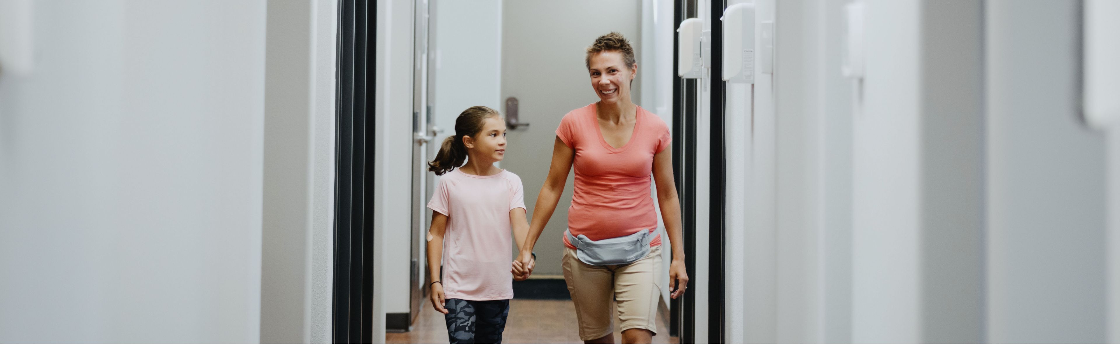 two female patients holding hands and walking