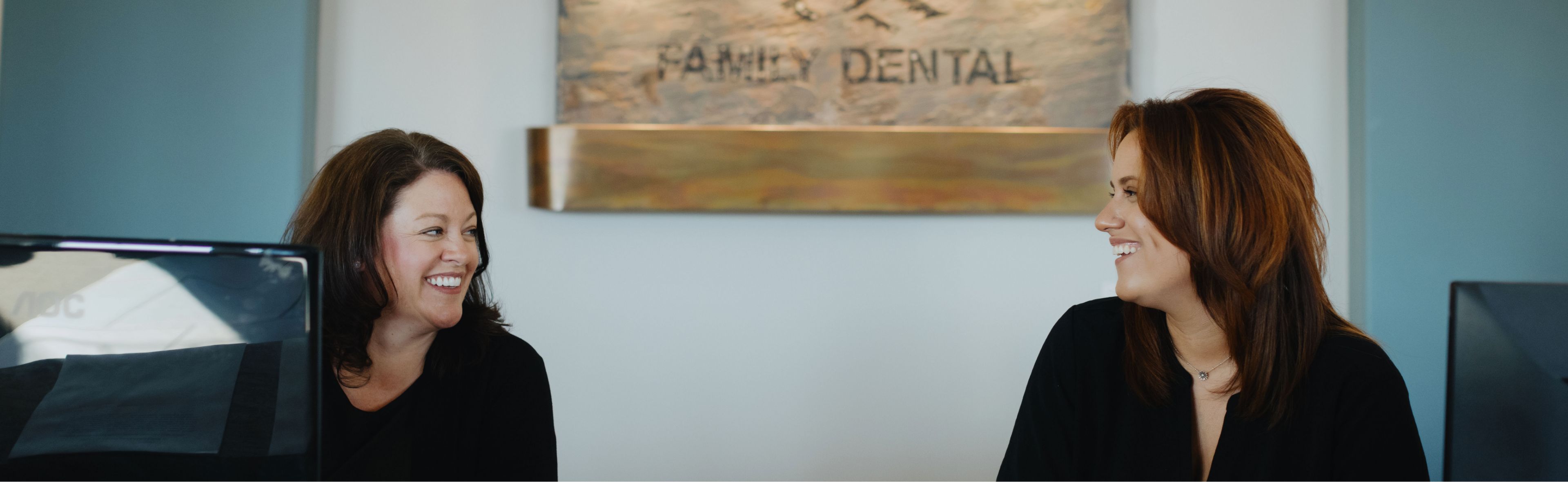 a person smiling next to another woman