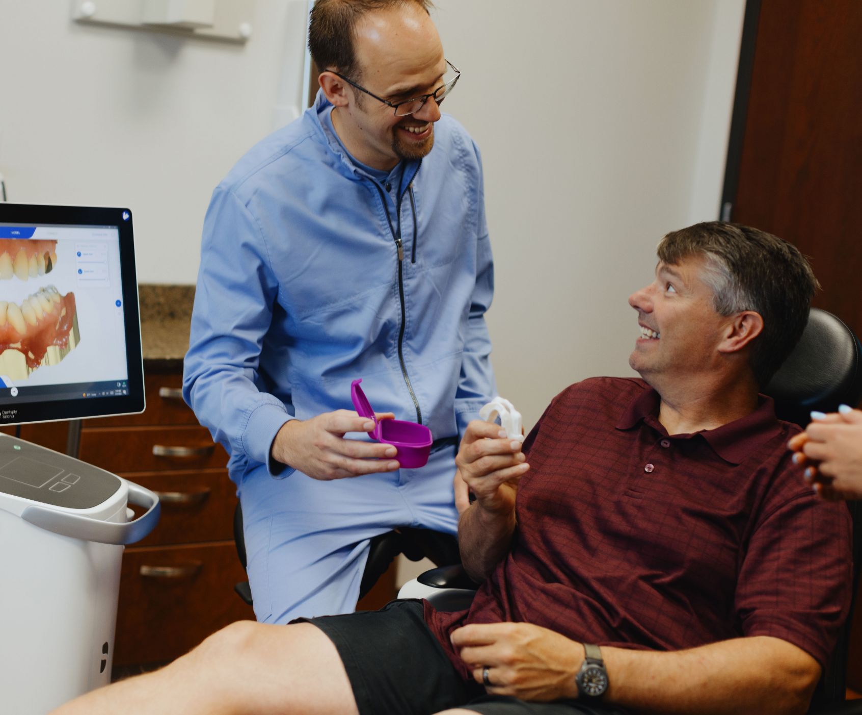 Dr. Adam Milmont smiling with a male patient
