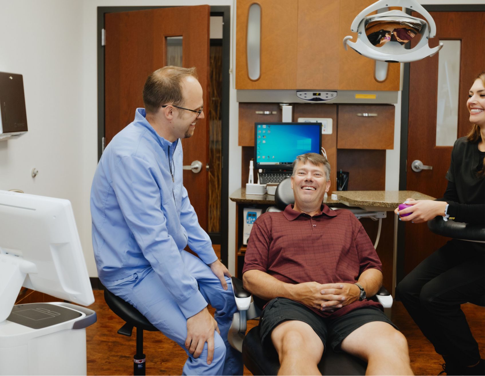 Dr. Adam Milmont smiling with a male patient