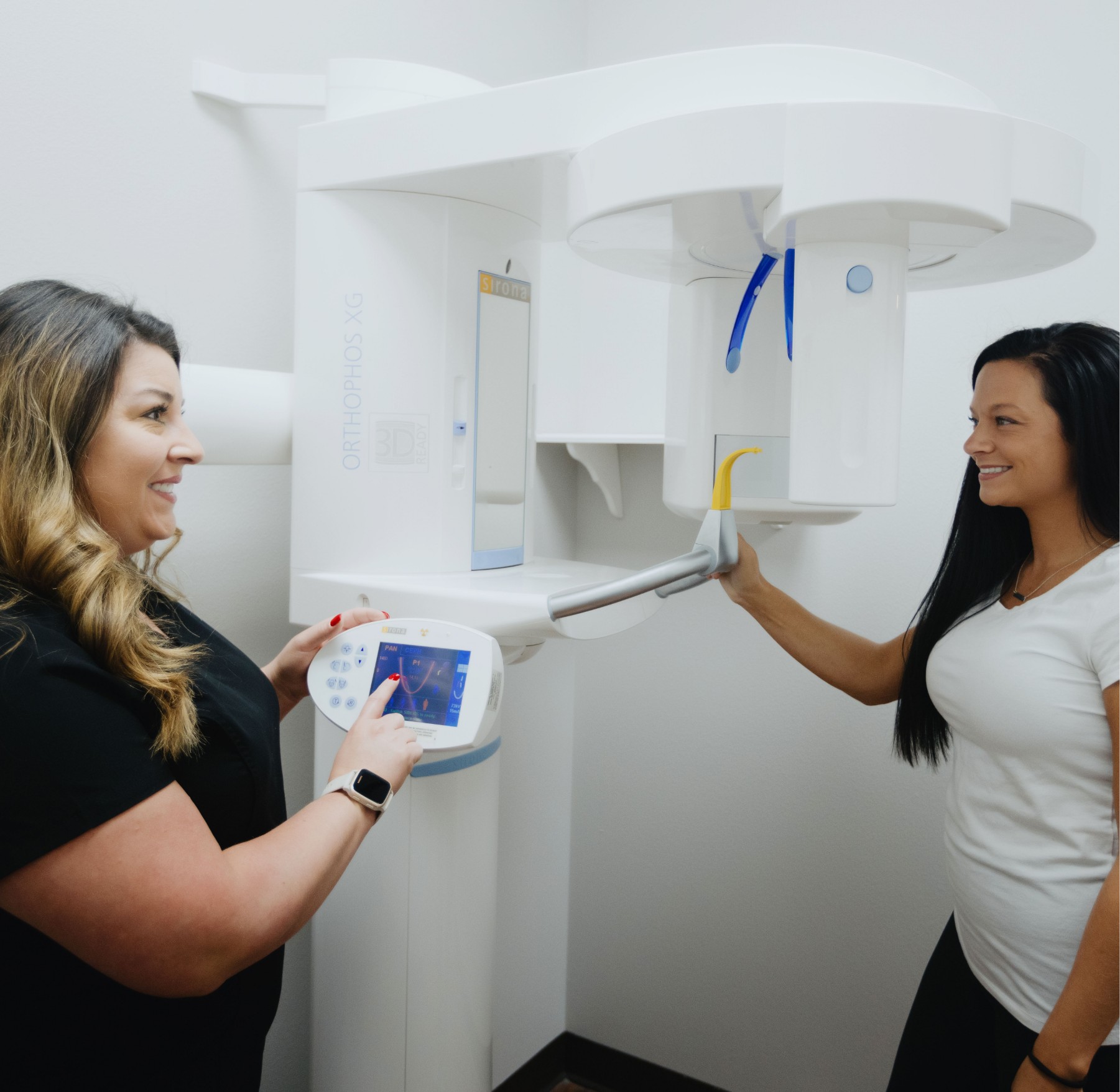 a woman showing a woman something on the machine