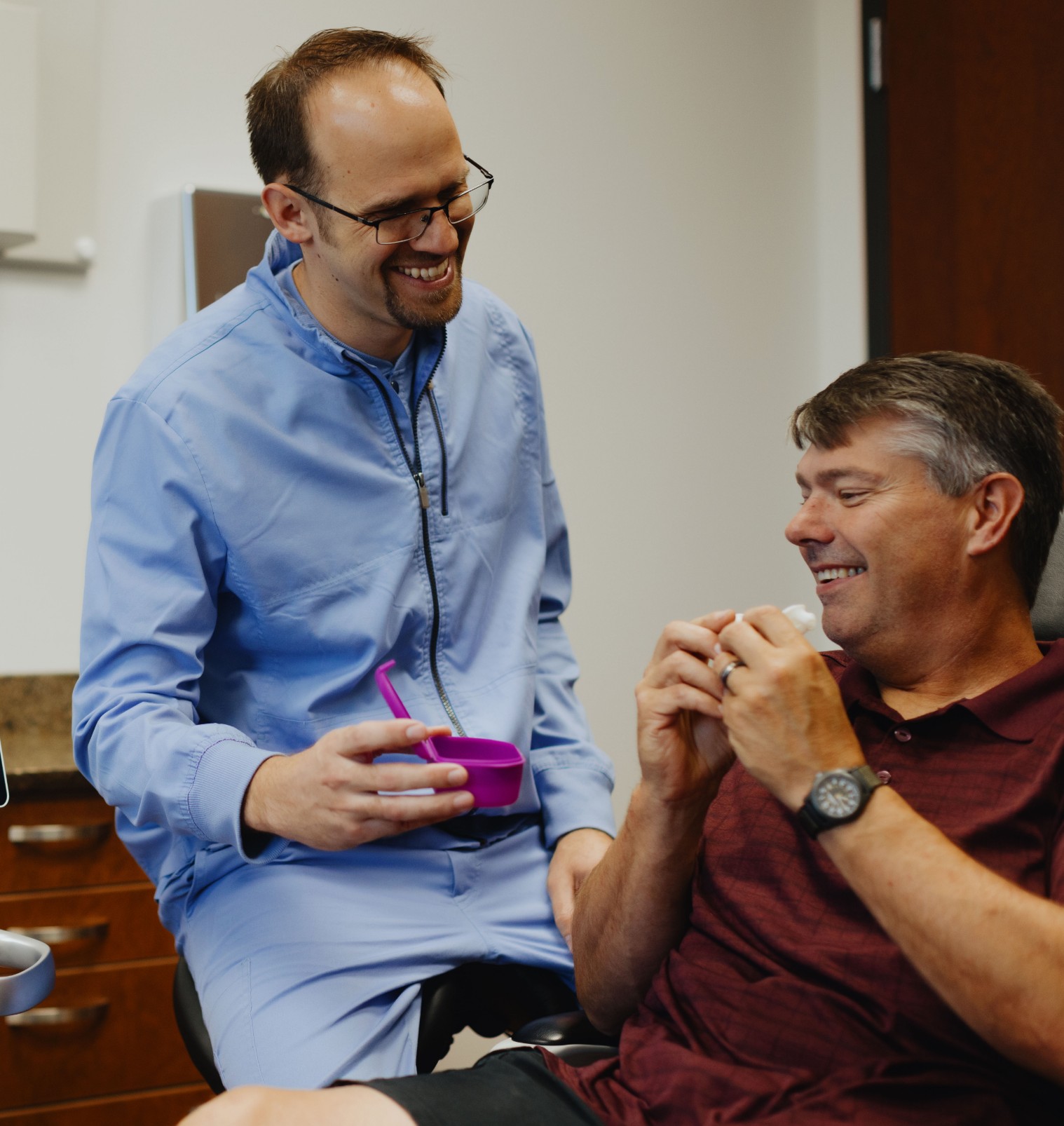 Dr. Milmont smiling with male patient